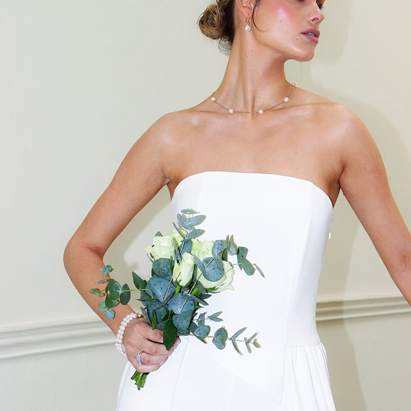 Wearing pearl bracelet, ncklace and earrings on your wedding day.